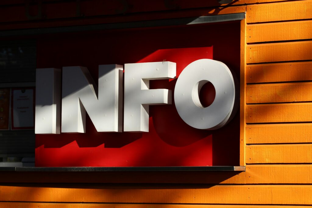 A sign saying "Info" in half shadow